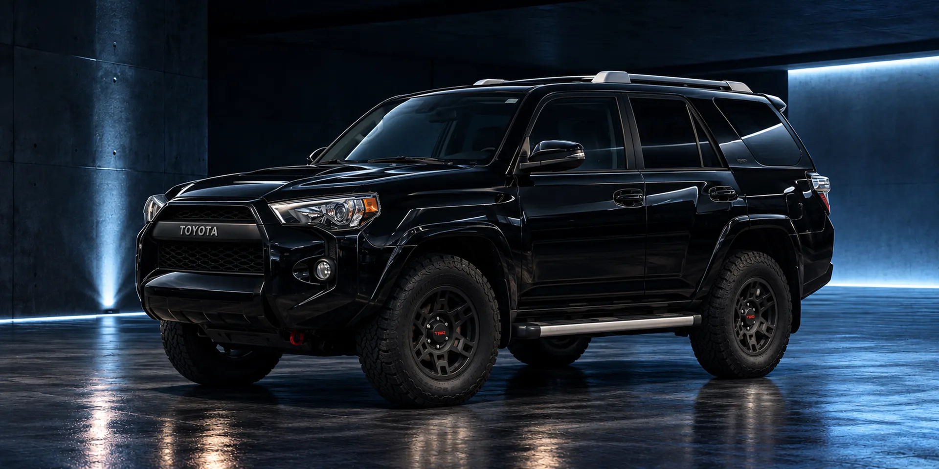 Black Toyota 4Runner, front three-quarter view, in a dark concrete garage